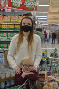 Atherton Leigh Foodbank fundraiser Leo Kelly and mum in supermarket